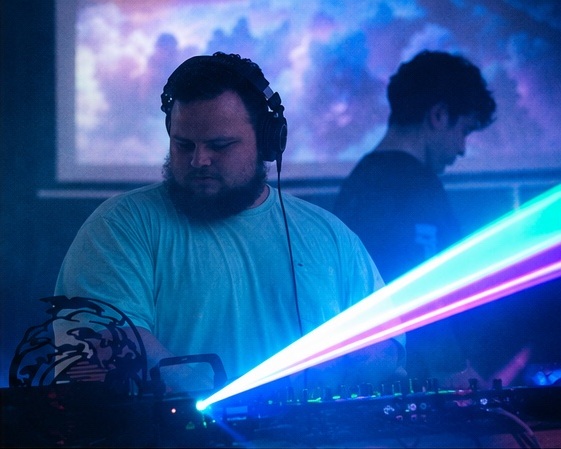 NØXIM performing with blue laser lights